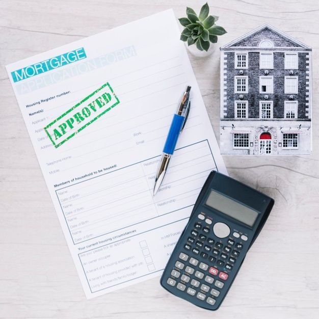 Calculator and mortgage paperwork on a desk